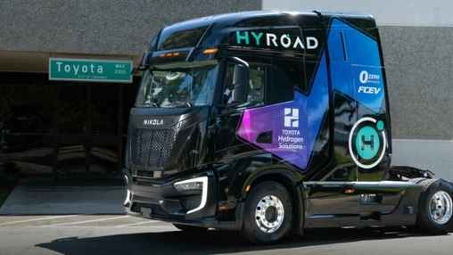 Black Nikola hydrogen fuel cell truck with HYROAD and Toyota Hydrogen Solutions branding parked on a street