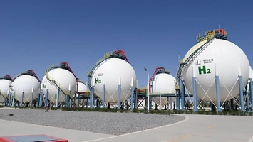 Large white spherical hydrogen storage tanks with H₂ labels and Sinopec branding at an industrial site